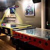 An air hockey table and a foosball table in a bar