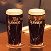 Two pints of Guinness on a table