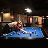 A woman playing pool