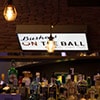A bar with a Buskers on the Ball sign on the wall