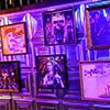 Framed pictures of quirky posters hung on a wall to a purple backdrop