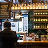 The bar at Jameson Whiskey distillery, with a woman sat at a stool