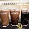 Three pints of Guinness at different levels of settling