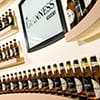 Lots of bottles of Guinness lined up on shelves on a cemi-circular wall