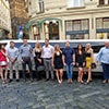 A group of people posing in front of a limo in the street