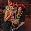Two women drinking from straws in a jug