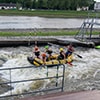 People white water rafting in a river