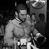A butler in the buff pouring a drink