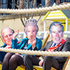 Some rope in the foreground wih masked Royals in the background, giving the camera the Royal Wave