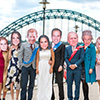 Last Night of Freedom staff wearing Royal Family masks in front of the Tyne Bridge in Newcastle