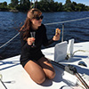 A girl eating pizza on board a yacht