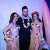  A man getting his picture with the hula girls