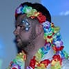  The side profile of a man with a lei around his head