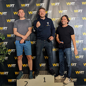  Three men standing on a podium following go-karting