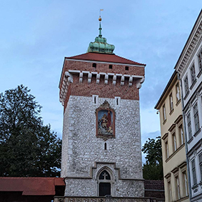  A grey and red tower in the Polish city of Krakow
