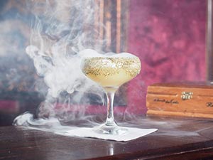 A smoking cocktail in a martini glass