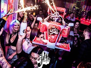 People carrying a go kart with sparklers coming out of it, in Liverpool's Ink Bar