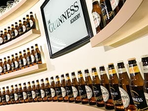 Some bottled Guinness lining the semi-circular walls of The Guinness Academy