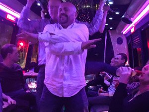 A man dancing in a strip limo
