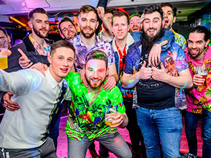 A group of men posing for a group photo in a bar