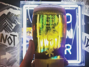 A close up of someone holding a pint