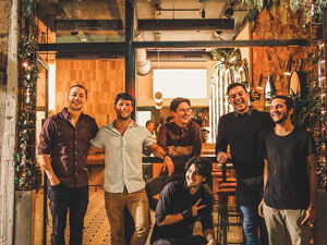 A group of men smiling in a bar