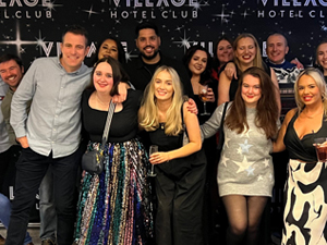 A group of people wearing reindeer masks and a Santa beard in the LNOF office