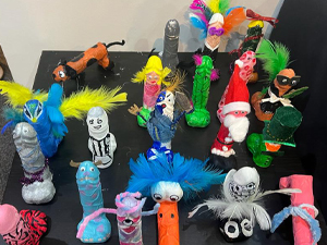 A table covered in painted plaster of Paris penises