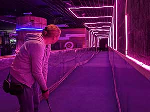 A woman playing mini golf 