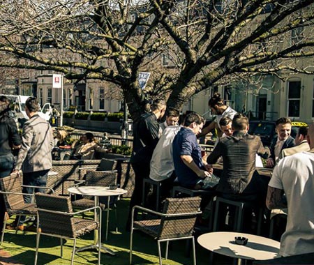 People sat outside Osbornes in the beer garden, during the day