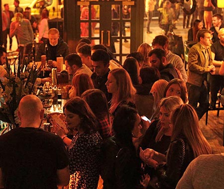 People at the bar of Passing Clouds