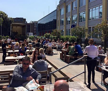 People sat in the beer garden of The Church Bar and Restaurant