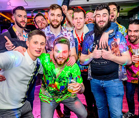 A group of men posing for a group photo in a bar