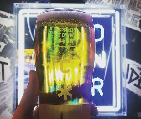 A close up of someone holding a pint