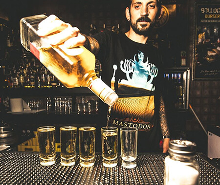 A bartender serving shots