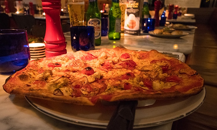 A pizza served up on a plate