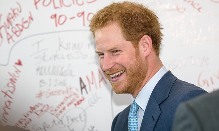Prince Harry turning to the side and laughing