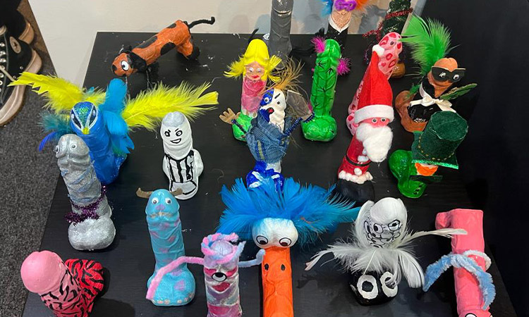 A table covered in painted plaster of Paris penises