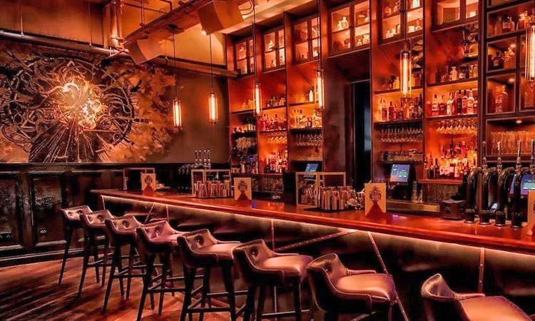 The interior of The Alchemist bar, with stools up at the bar