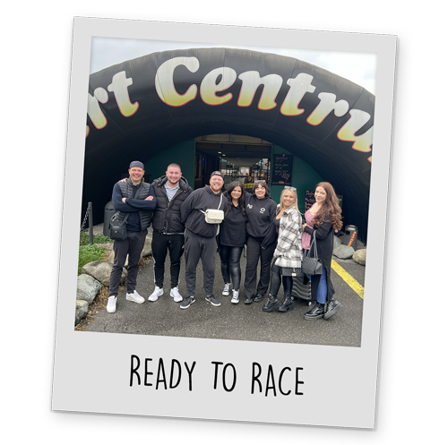 A polaroid style image of a Team LNOF outside of the go karting venue, with text reading 'Ready To Race' at the bottom