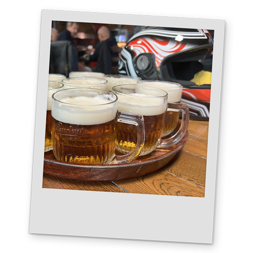 A polaroid style image of a tray of beer and a helmet