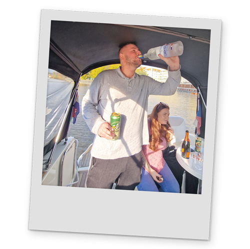 A polaroid style image of one of team drinking from a bottle of vodka on the river cruise