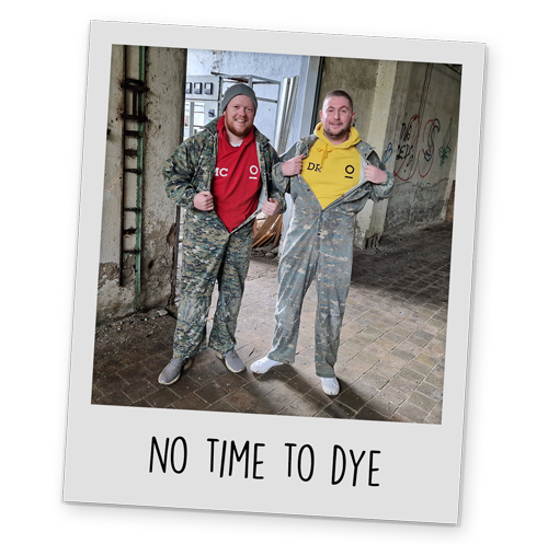 A polaroid style image of two of Team LNOF posing with camo overalls on, with text reading 'No Time To Dye' at the bottom