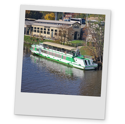 A polaroid style image of a boat on Prague's river