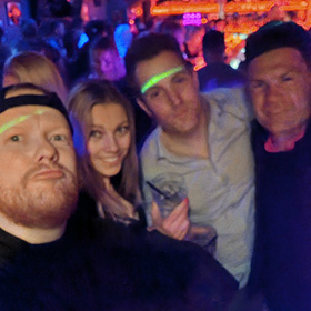A group of people in a nightclub enjoying Prague's nightlife
