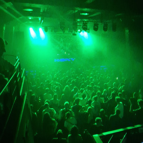 The interior of a nightclub with neon green lights