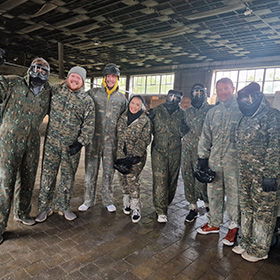  A group of people in camo overalls at paintballing