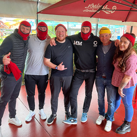 A group of people at Go Karting, some with balaclavas on