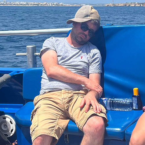 A male member of our team who's fallen asleep on a boat on the Atlantic ocean 