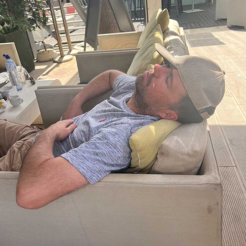 A male member of our team who has fallen asleep on the sofas at the Waterfront bar in Albufeira 